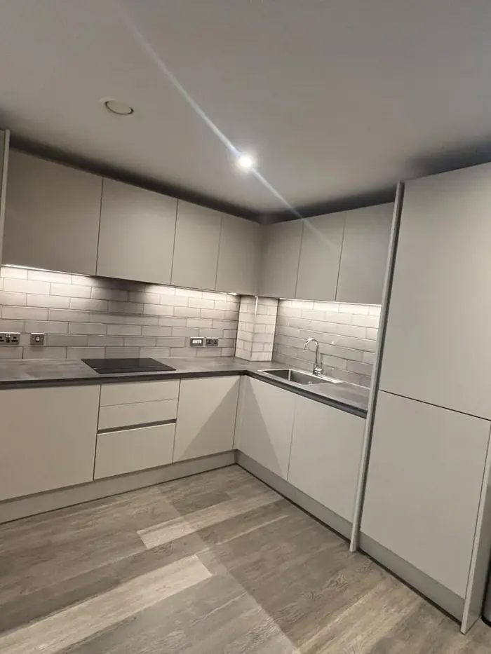 Fitted kitchen with clean worktops and cupboards after an end of tenancy clean