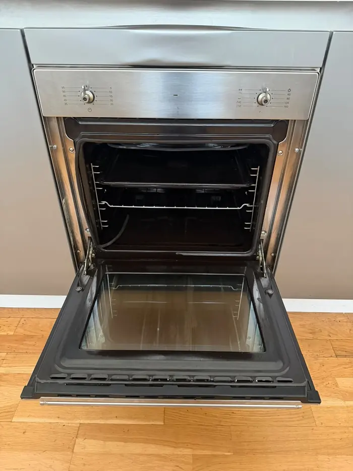 Built-in oven open, cleaned inside with clear glass door