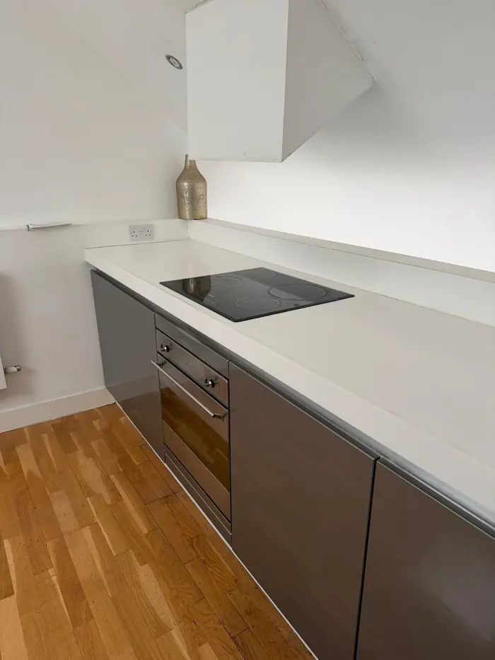 White worktop and hob wiped down in a modern kitchen